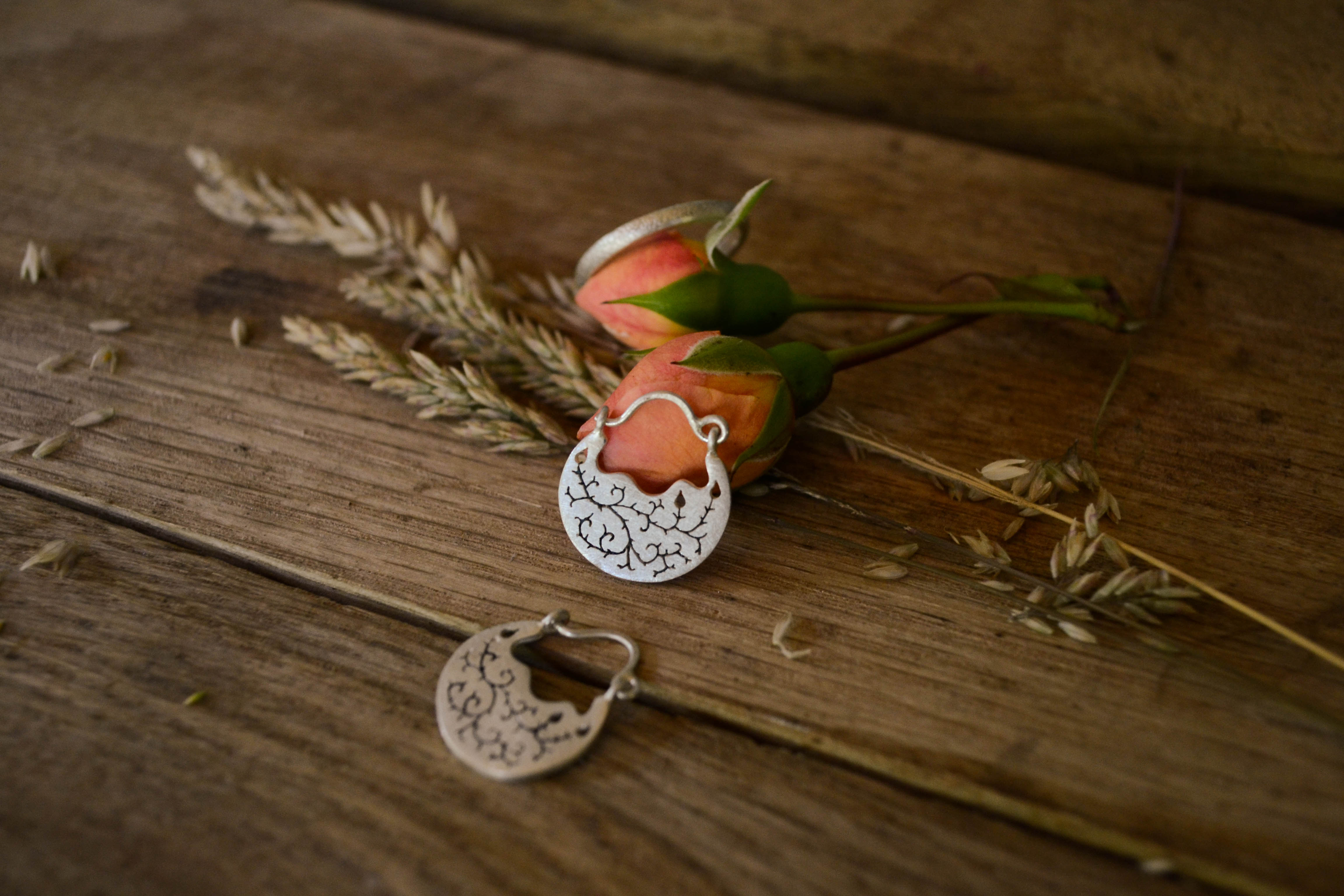Bramble earrings and ring on oak