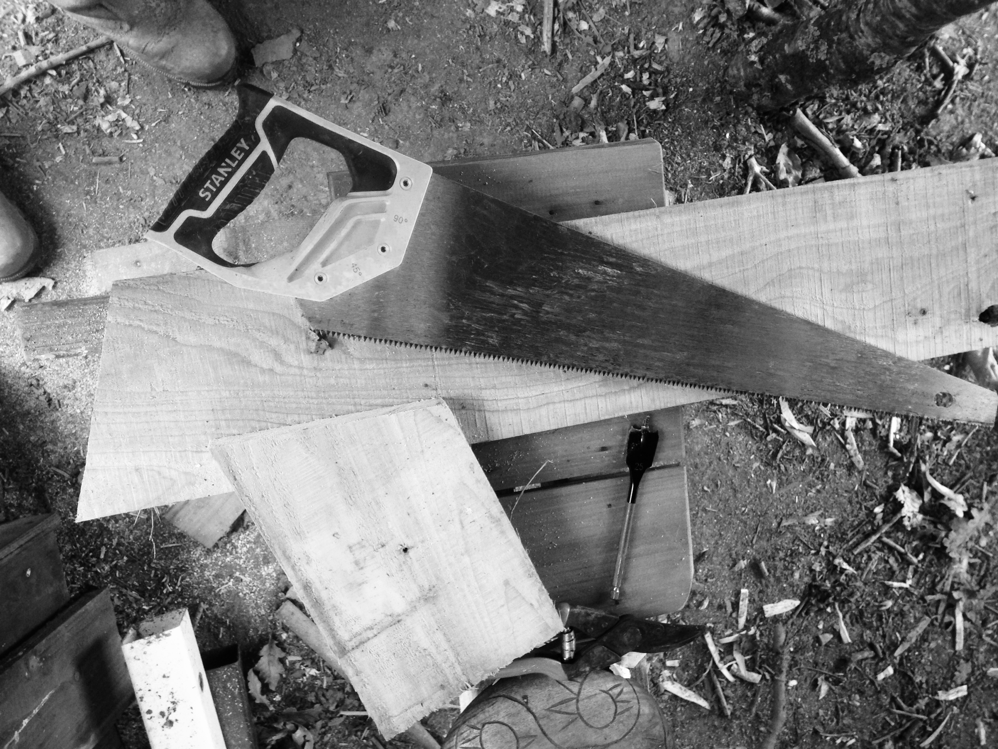 Saw and wood in black and white