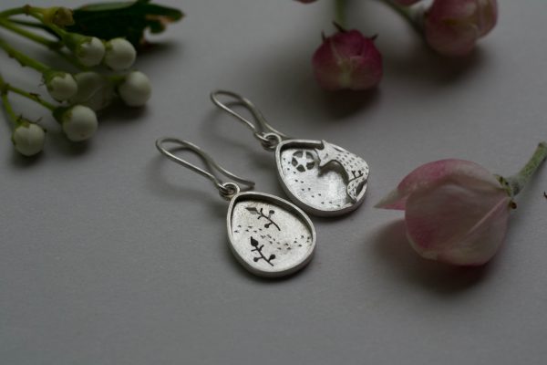 Front of silver fox earrings with flowers