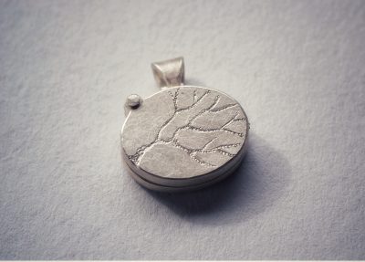 Front of locket on grey
