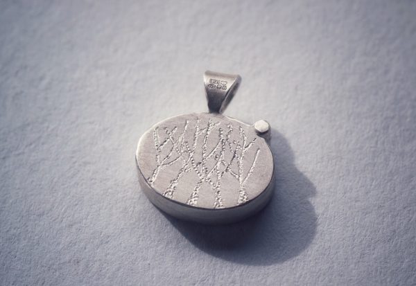 Back of locket on grey
